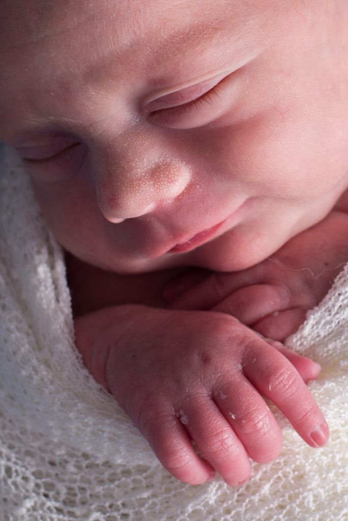 newborn in a white wrap